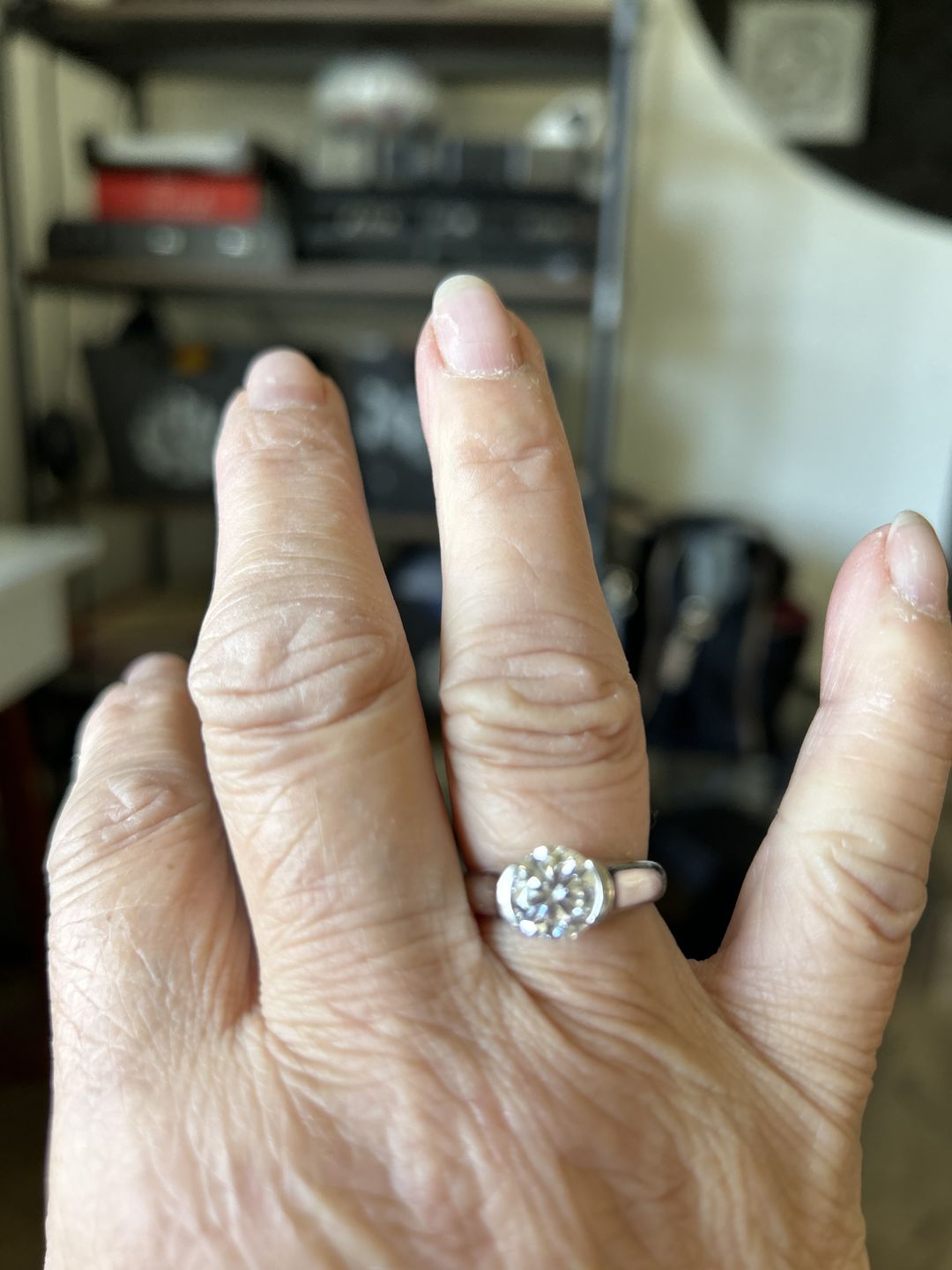 Customer photo review of Solitaire Moissanite Half Bezel Set Sterling Silver Engagement Ring
