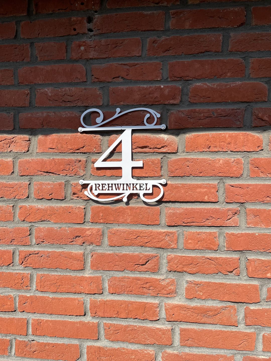 Customer photo review of Hausnummer Türschild mit Ornament und Familiennamen aus edlem Stahl