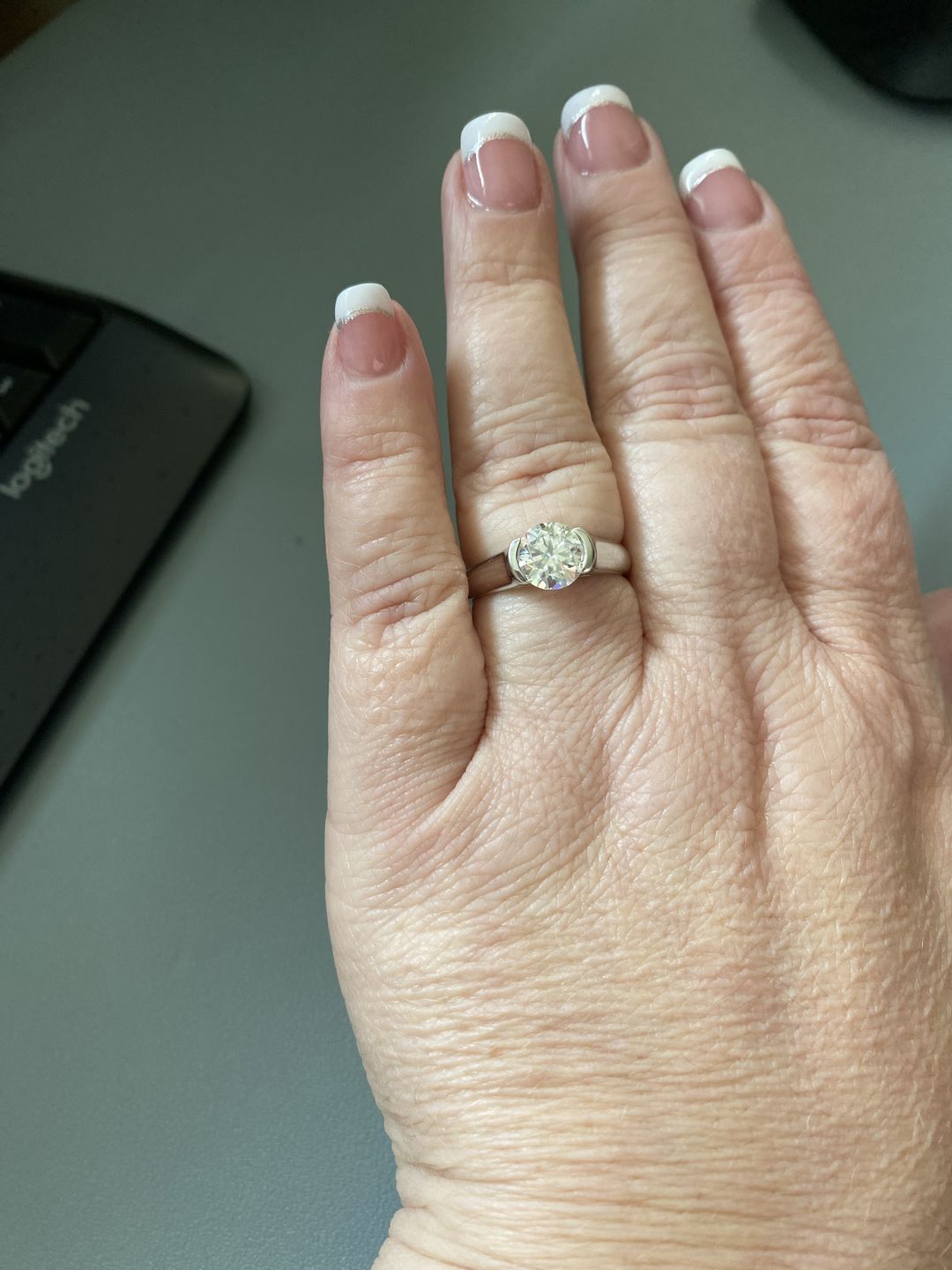 Customer photo review of Solitaire Moissanite Half Bezel Set Sterling Silver Engagement Ring