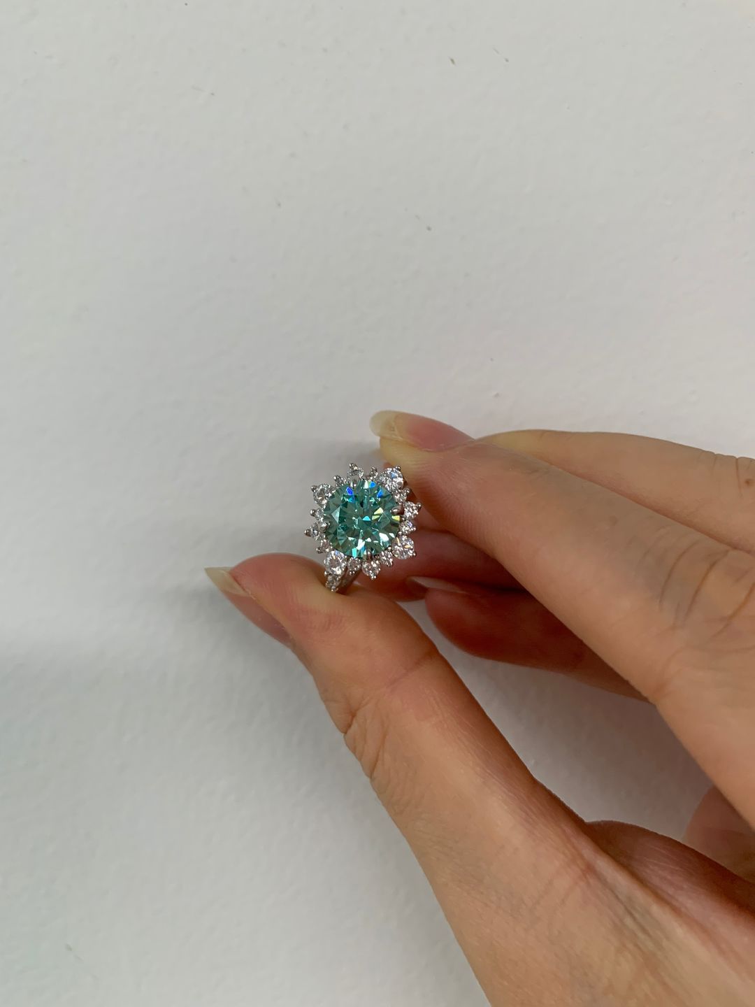 Customer photo review of S925 Moissanite 2 Ct Snowflake Design Halo Round Cyan Blue Stone Engagement Ring