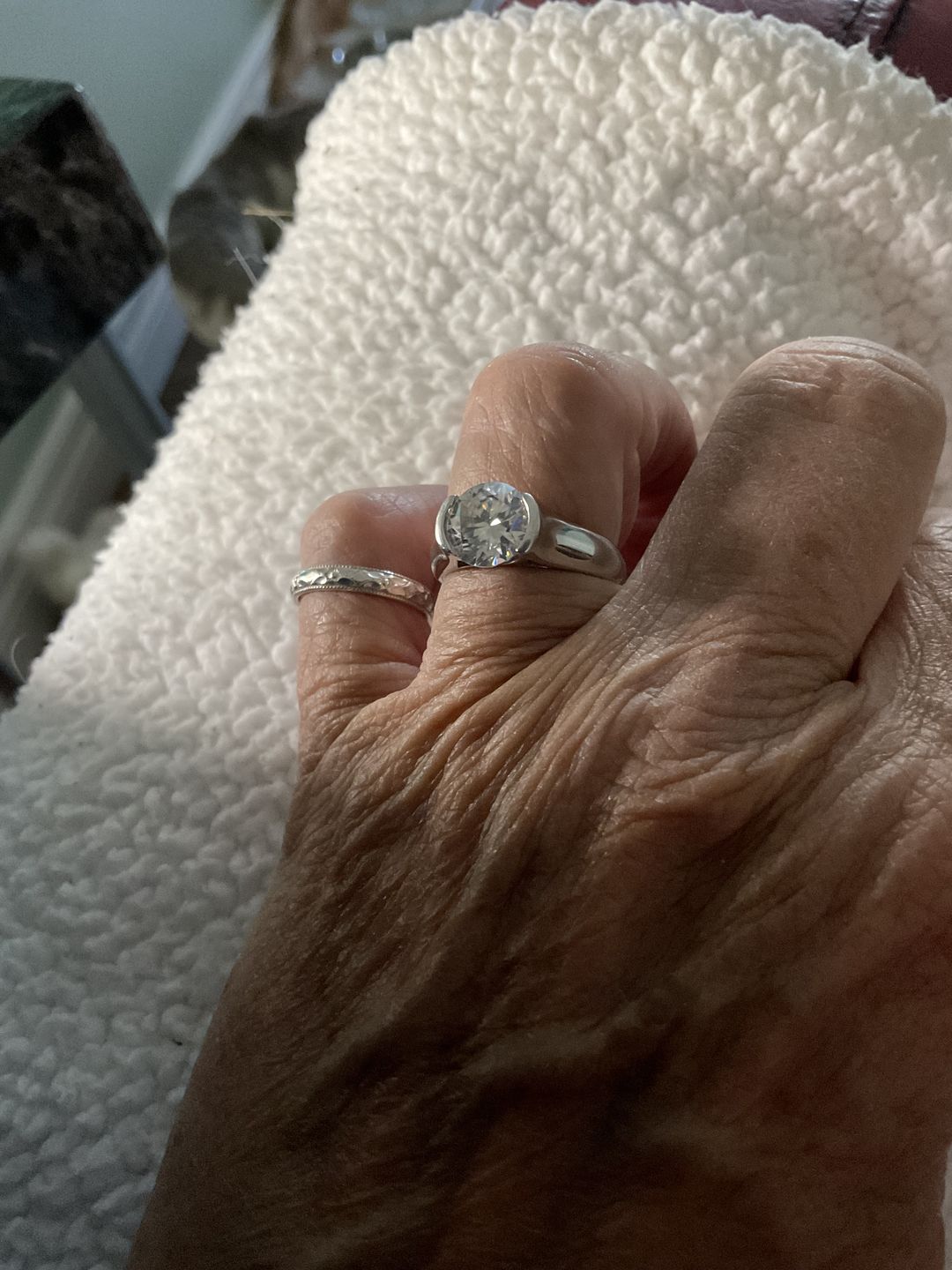 Customer photo review of Solitaire Moissanite Half Bezel Set Sterling Silver Engagement Ring