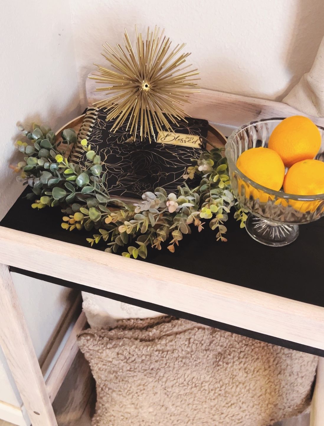A stained side table sealed with Furniture Shield, styled with oranges and greenery