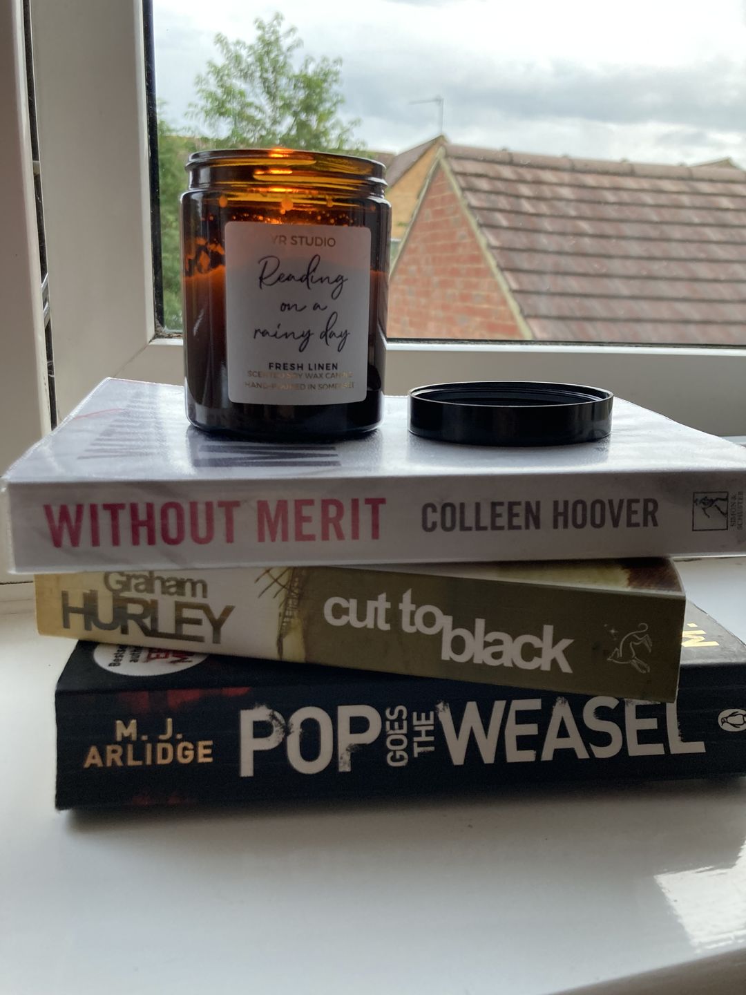 Customer photo review of “Reading on a rainy day” Fresh Linen Candle in Amber Jar