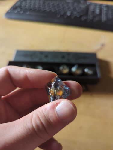 Customer photo review of Orange Sand Liquid Core Dark Blue Resin DnD D&D Dice Set