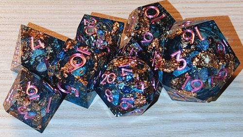 Customer photo review of URWizards D&D Pale Blue Liquid Heart Resin Engraved Dice Set Copper Flakes