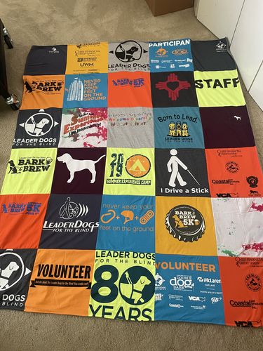 T-shirt quilt with dog training, community service themes by Susan from NM