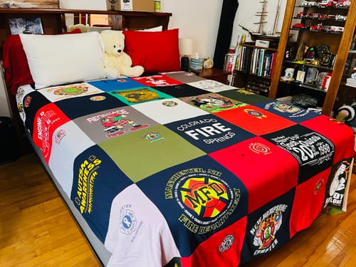 T-shirt quilt with firefighting, community service themes by Linn from NH