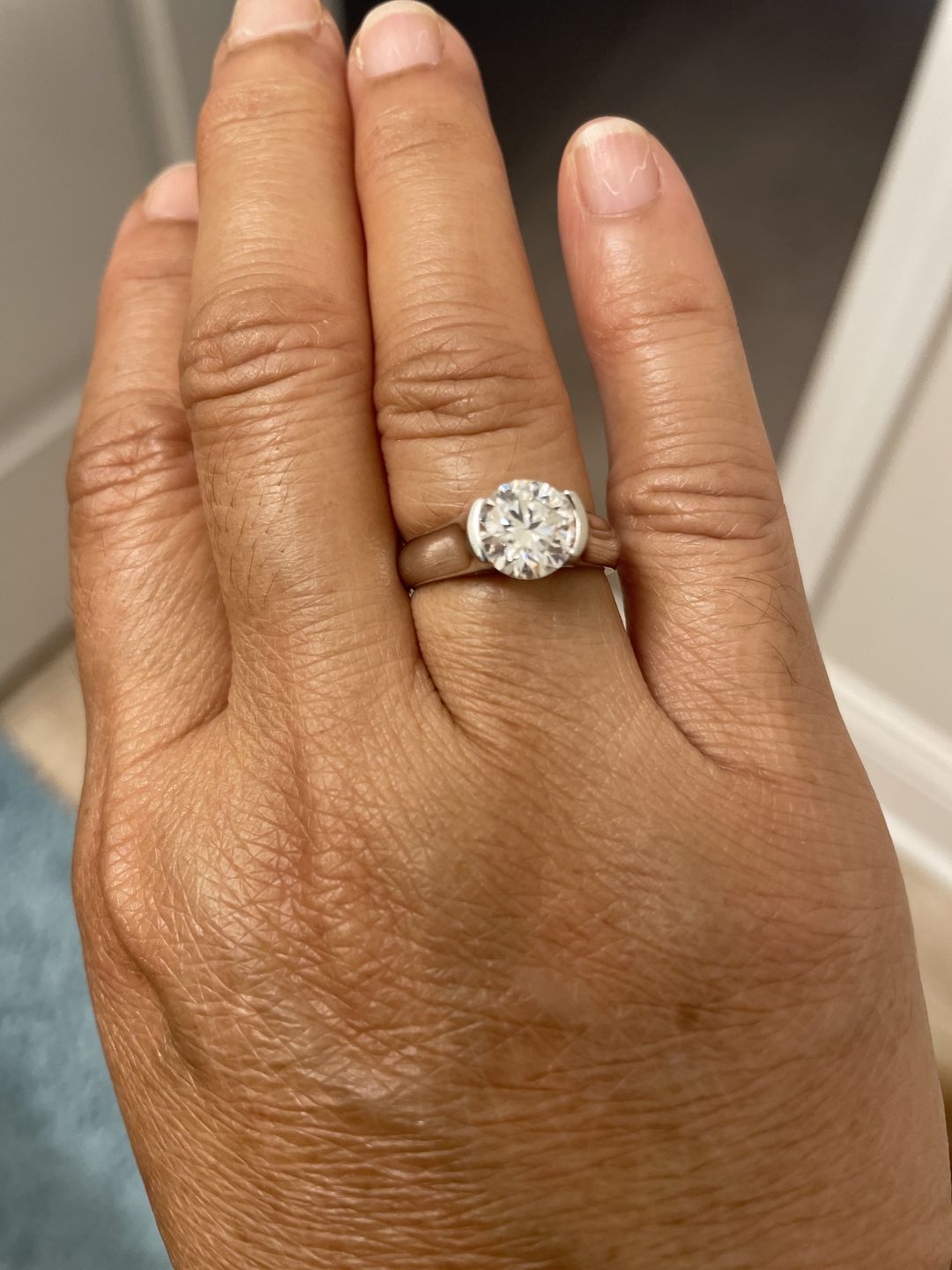 Customer photo review of Solitaire Moissanite Half Bezel Set Sterling Silver Engagement Ring