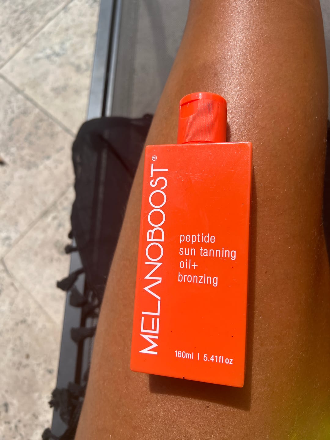 Customer photo review of Melanoboost Peptide Sun Tanning Oil + Bronzing
