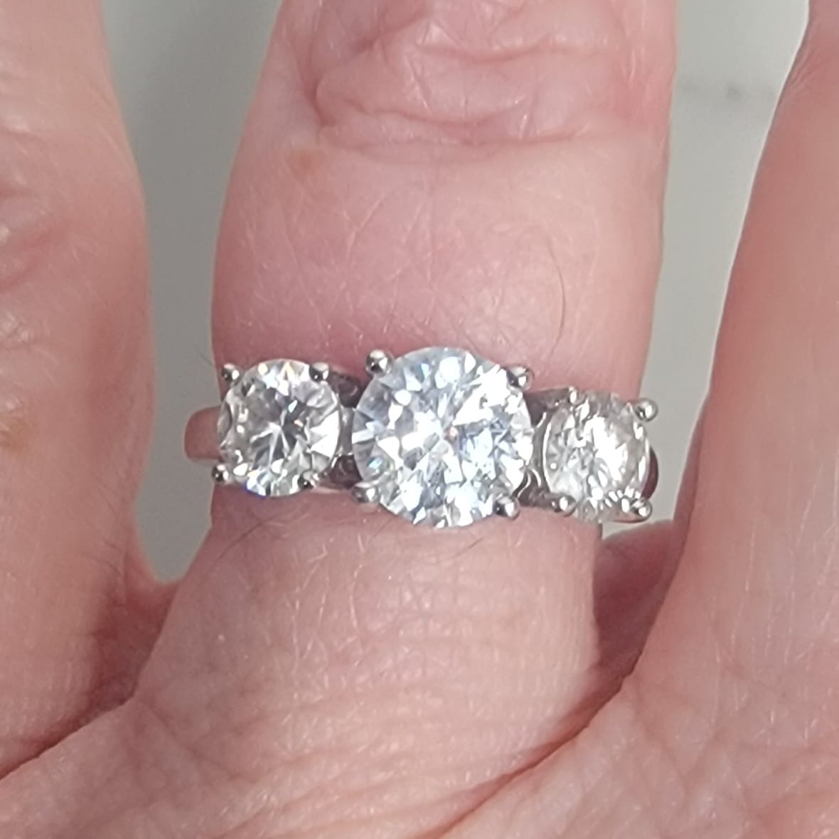 Customer photo review of Classic Three Stone Round Cut Moissanite Engagement Ring