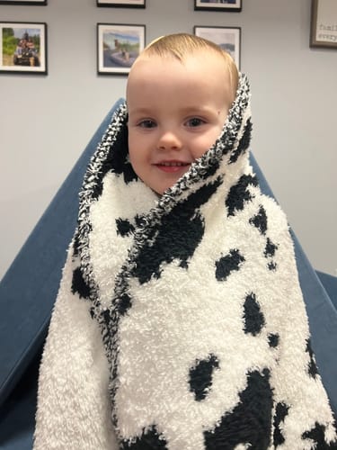 Customer photo review of Black & White Cow Print Toddler Blanket