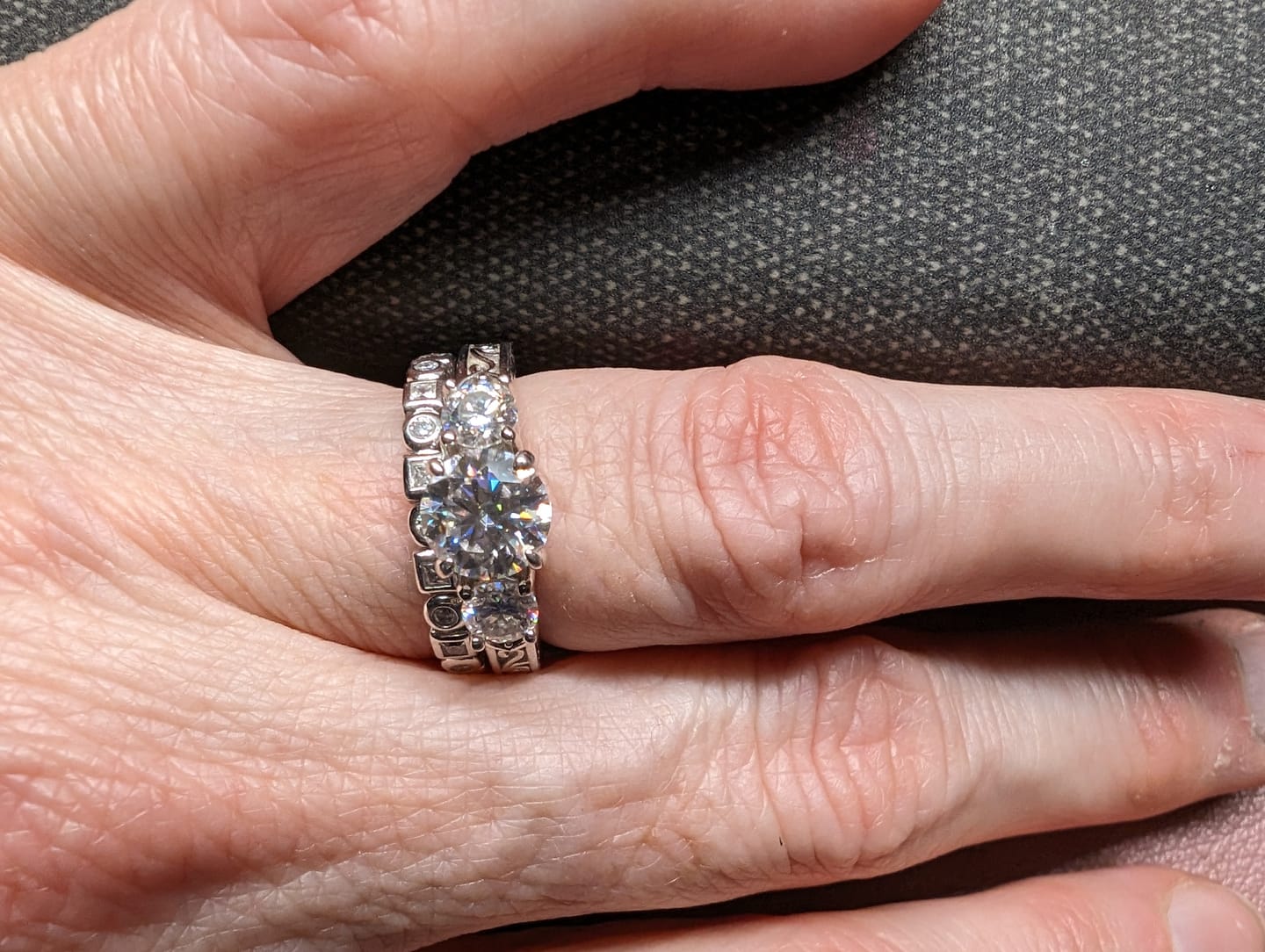 Customer photo review of Alternating Round And Princess Cut Moissanite Bezel Set Half Eternity Wedding Band