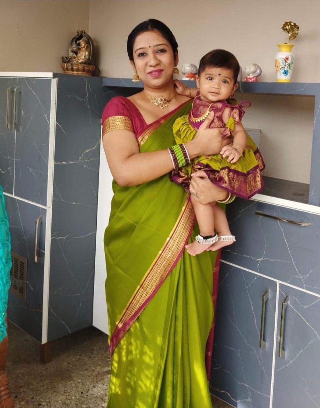 Customer photo review of Green and wine tie up dress for baby girl