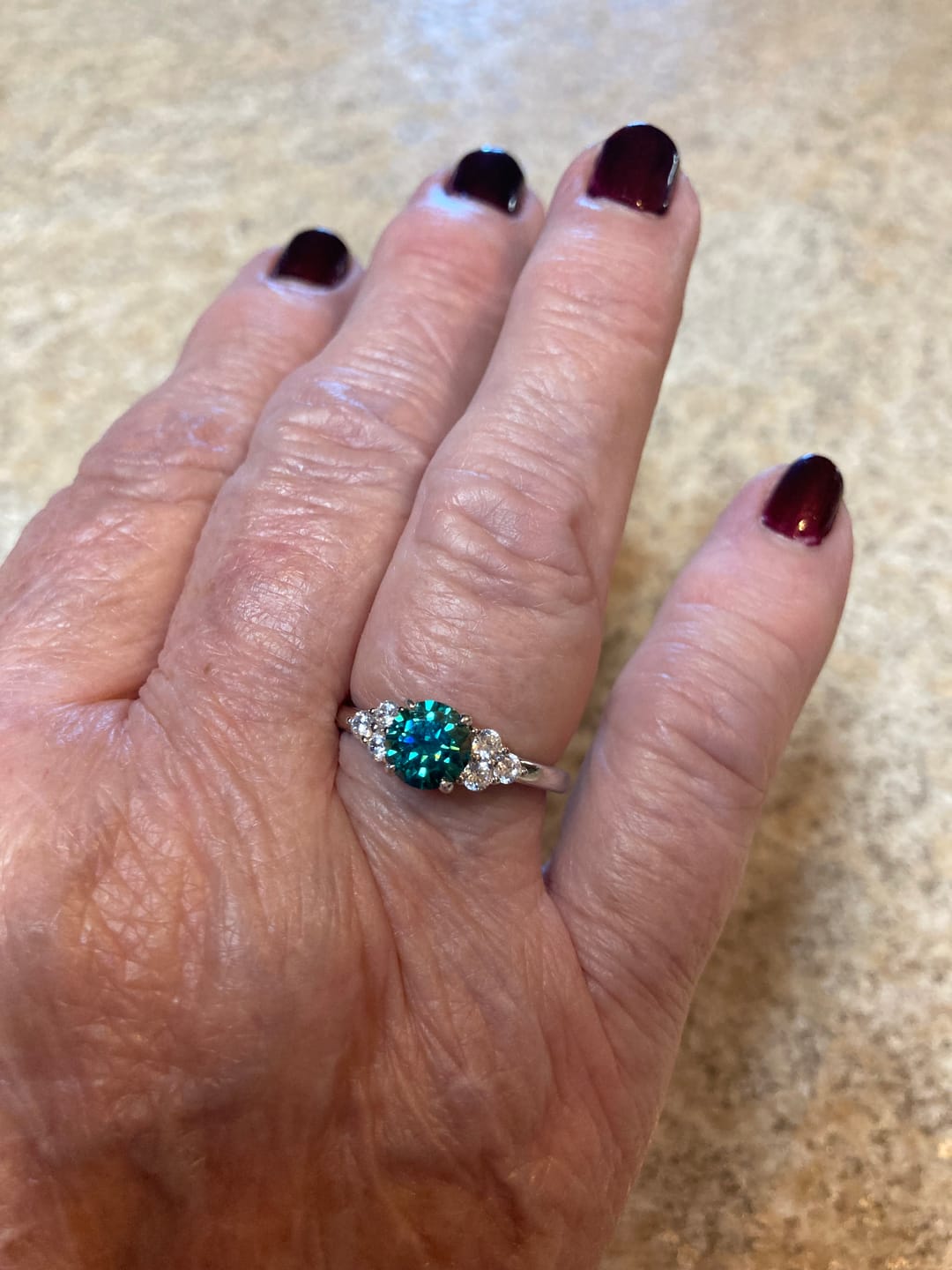 Customer photo review of Green Moissanite Side Stone Engagement Ring