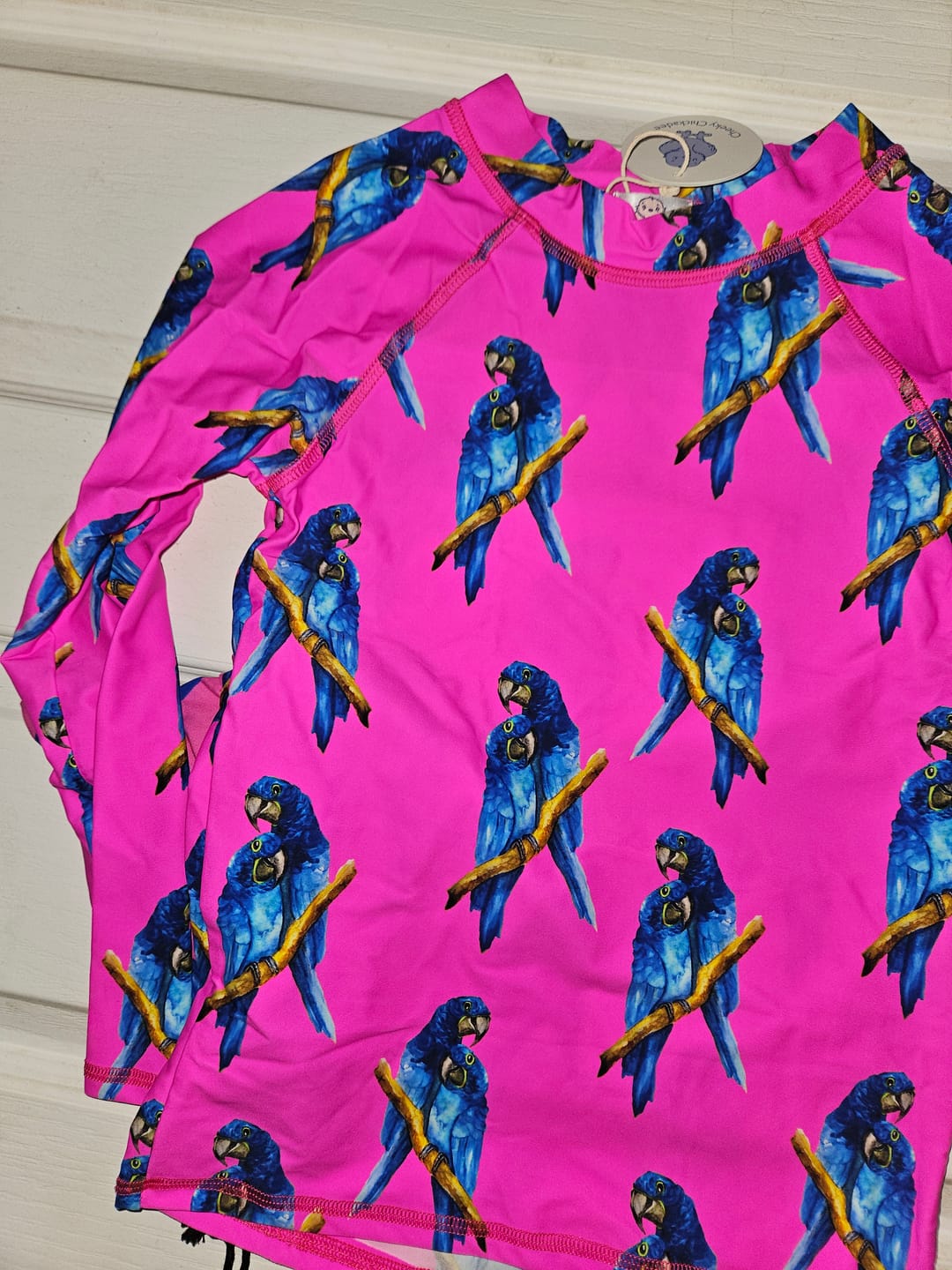 Customer photo review of Fluro Macaw Kids' Rash Top