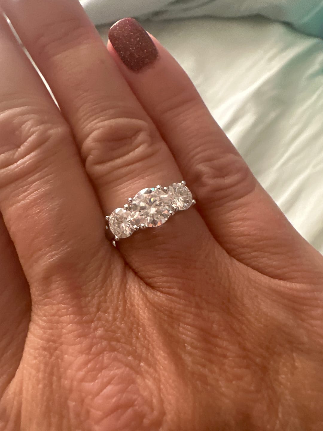 Customer photo review of Classic Three Stone Round Cut Moissanite Engagement Ring