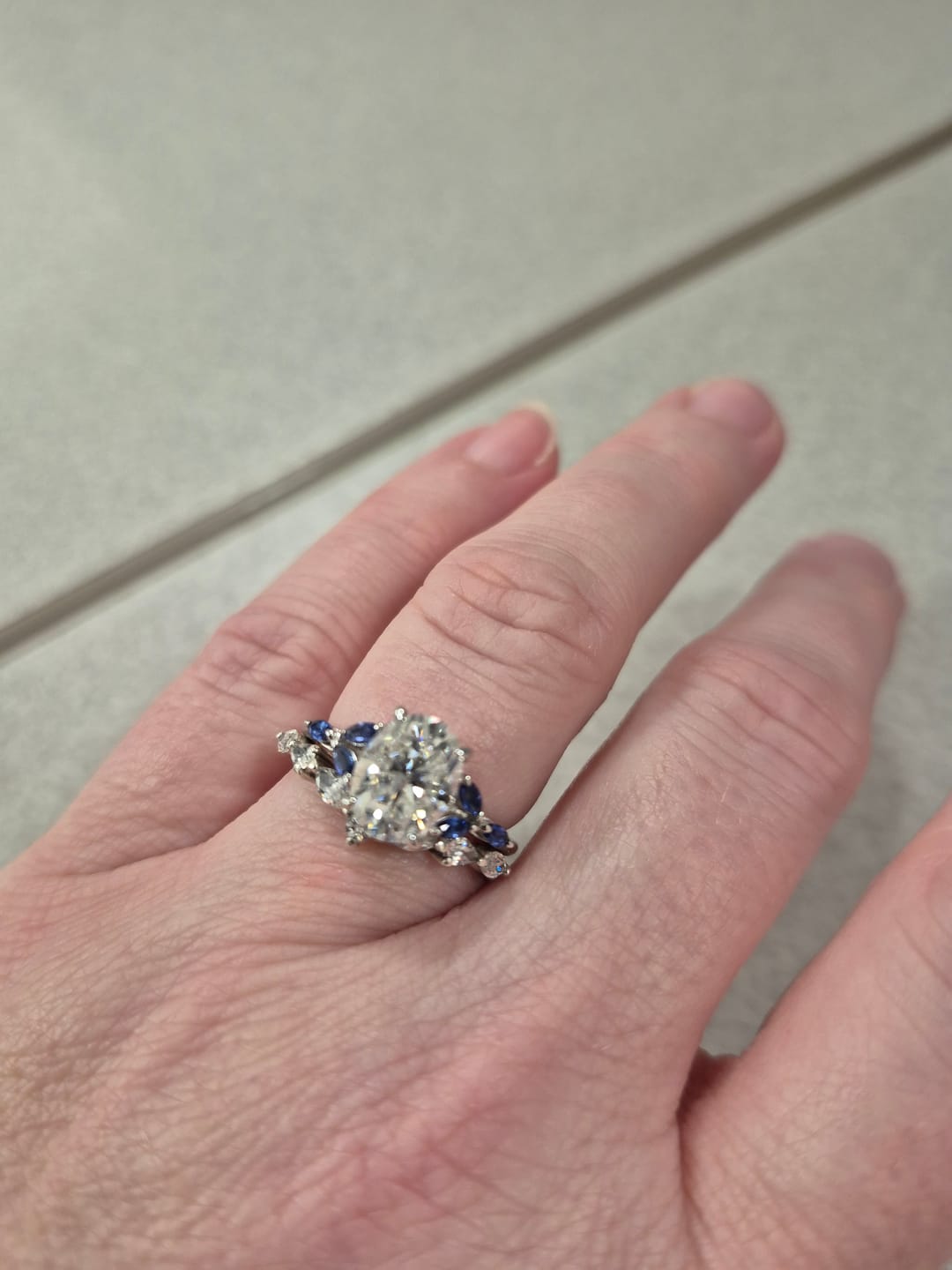 Customer photo review of Oval Cut Moissanite With Marquise Sapphire Petals Accents Engagement Ring