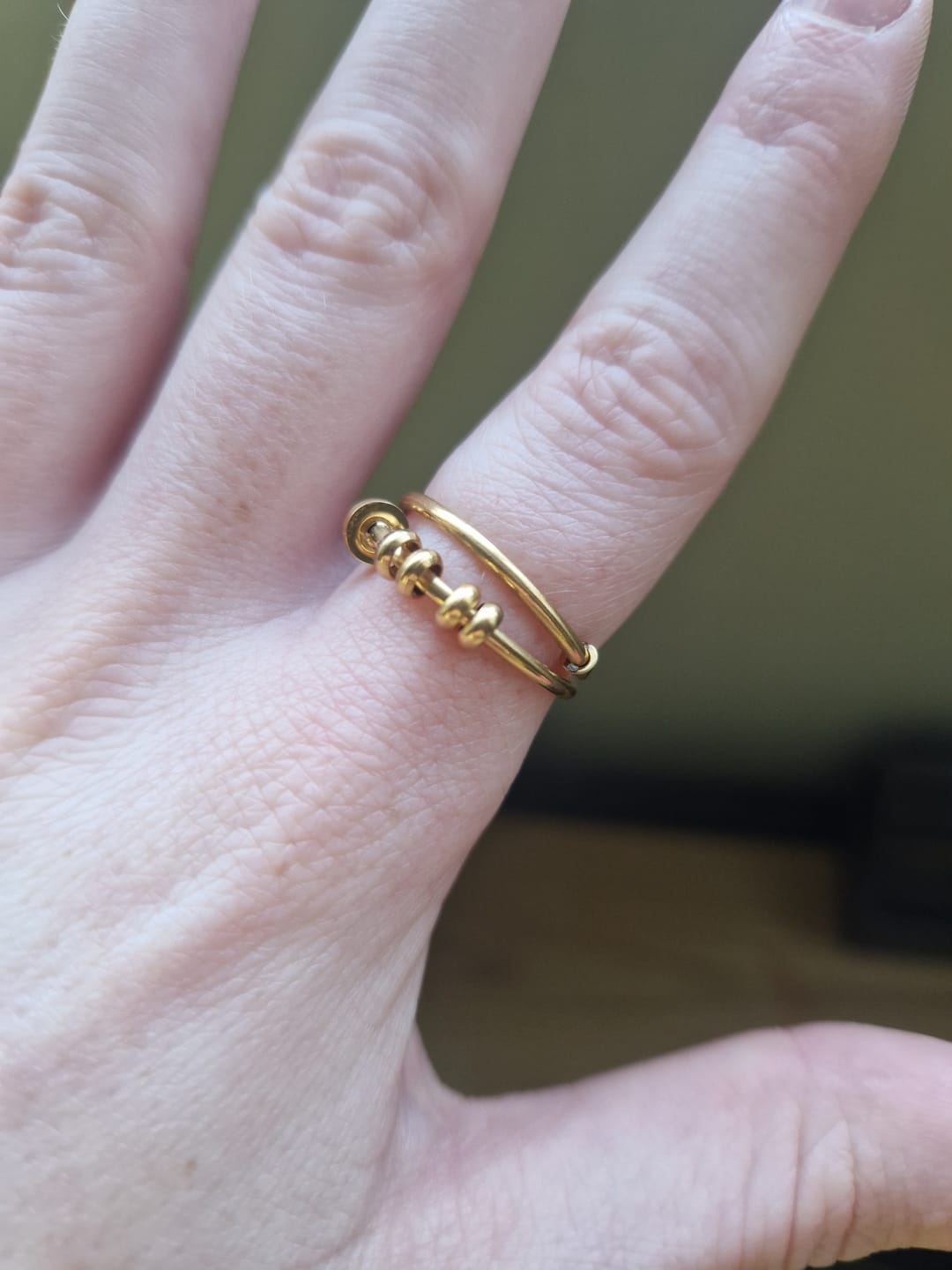 Customer photo review of gold 4-bead adjustable nail anxiety ring (316L)