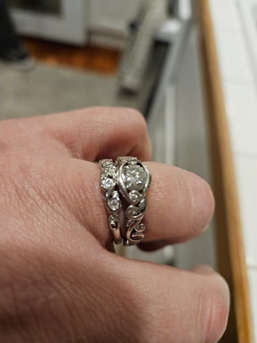 Laurie D. review of Bezel Set Round Moissanite Scroll Accents Wedding Band Ring In Sterling Silver image 1 out of 1