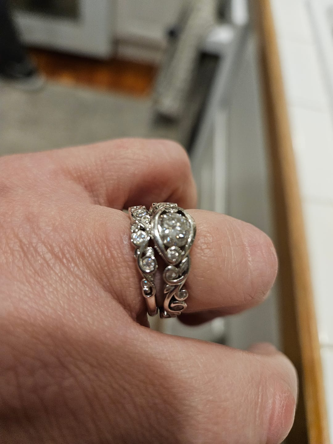 Customer photo review of Bezel Set Round Moissanite Scroll Accents Wedding Band Ring In Sterling Silver