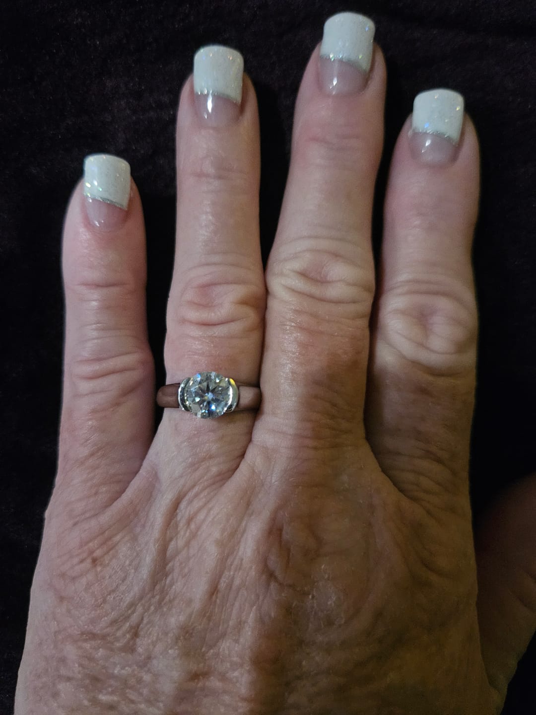 Customer photo review of Solitaire Moissanite Half Bezel Set Sterling Silver Engagement Ring