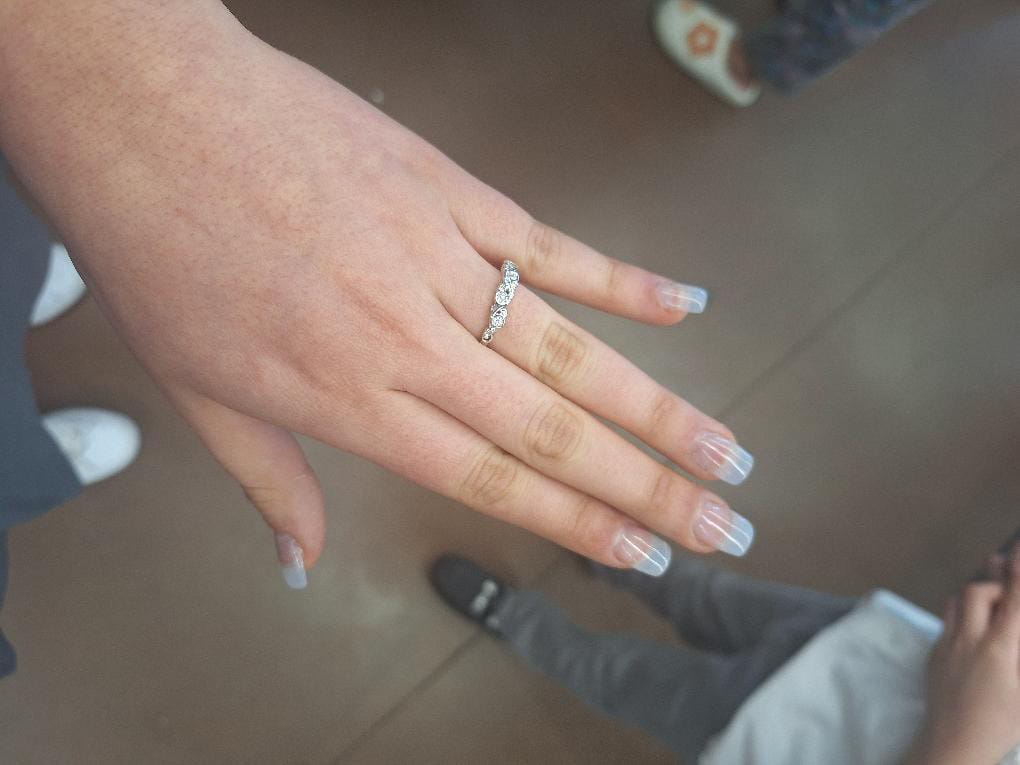 Customer photo review of Bezel Set Round Moissanite Scroll Accents Wedding Band Ring In Sterling Silver