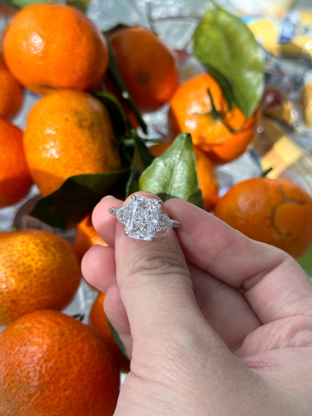 Customer photo review of Louily 5.0 Carat Radiant Cut Three Stone Engagement Ring With Two Heart Cut Side Stones