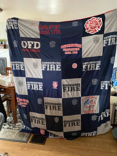 T-shirt quilt with firefighting, community service themes by Thomas from NY