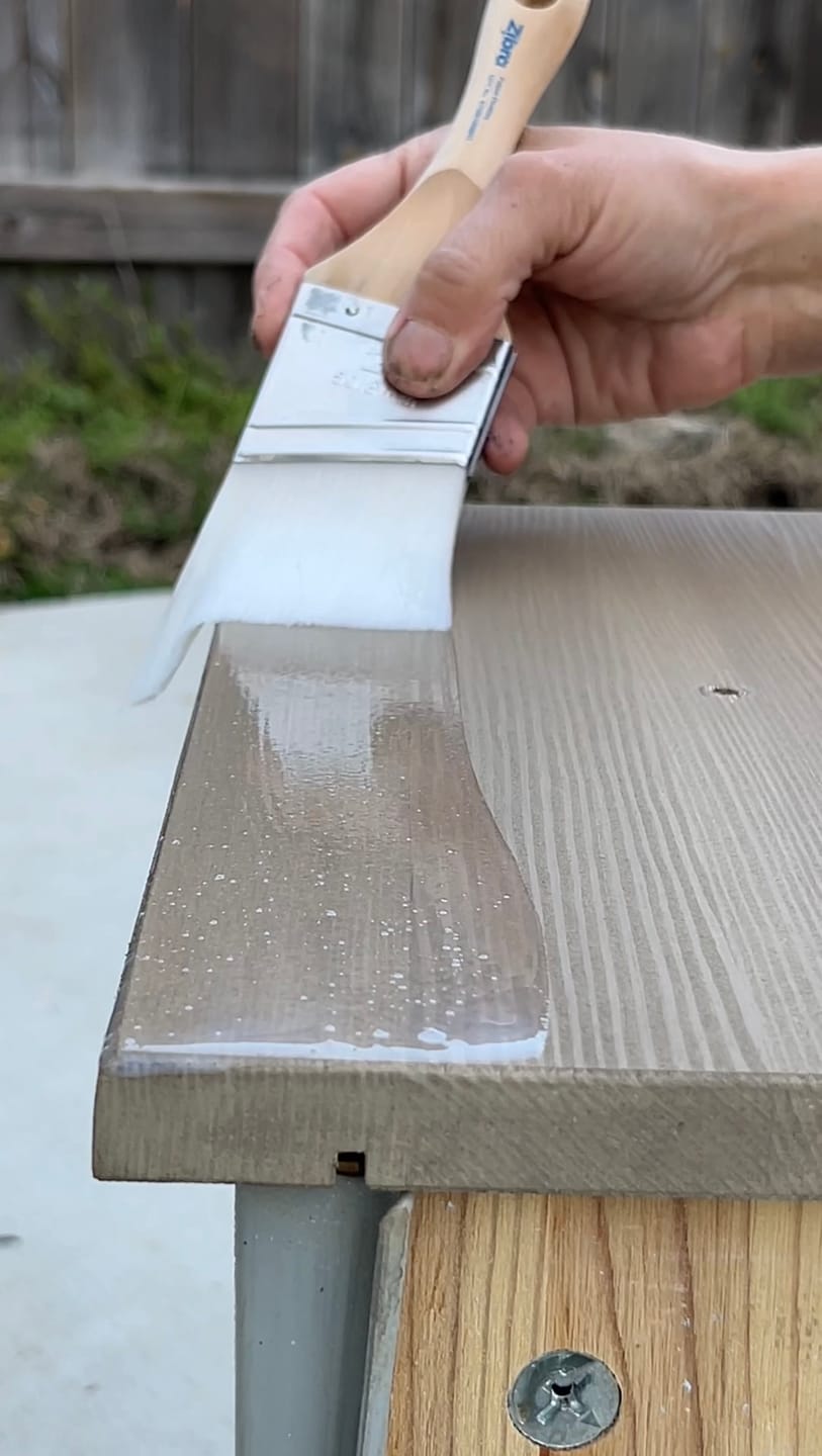 Brushing Furniture Shield onto a stained dresser top