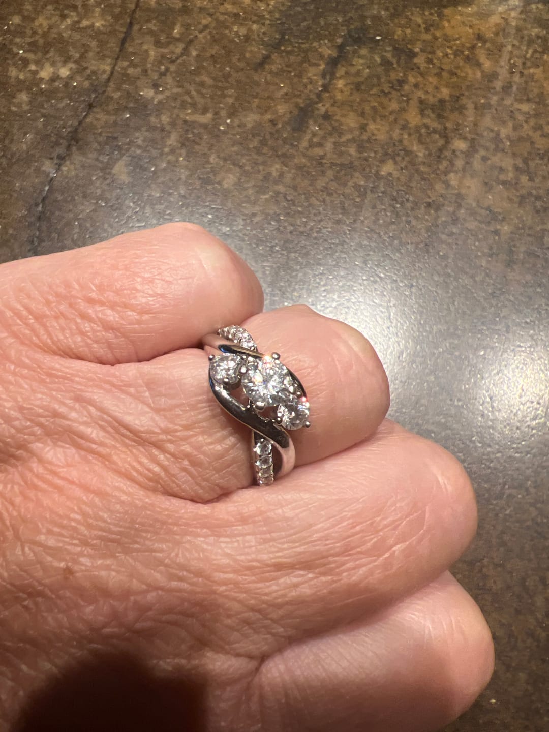 Customer photo review of Swirl Three Stone Moissanite Twisted Pave Engagement Ring