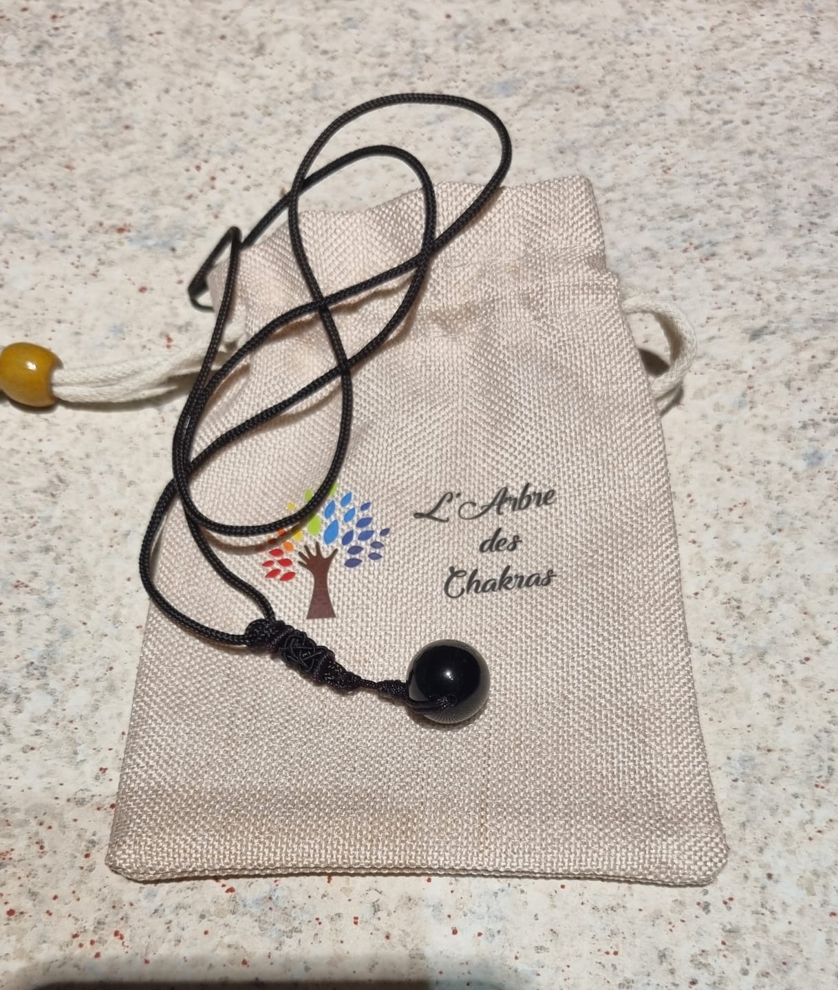 Customer photo review of Pendentif "Sphère" en Obsidienne Dorée