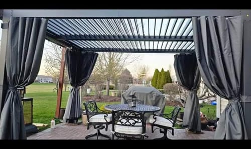 Customer photo review of EROMMY 10'×12' Outdoor Louvered Pergola with Adjustable Aluminum Rainproof Roof, Curtains and Netting Included, Black