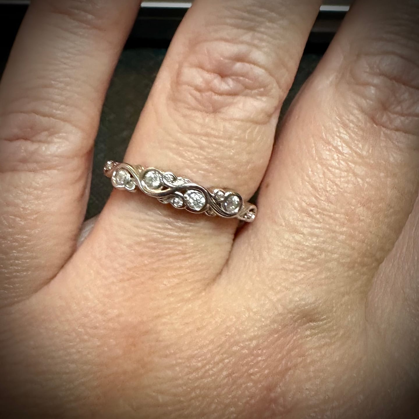 Customer photo review of Bezel Set Round Moissanite Scroll Accents Wedding Band Ring In Sterling Silver