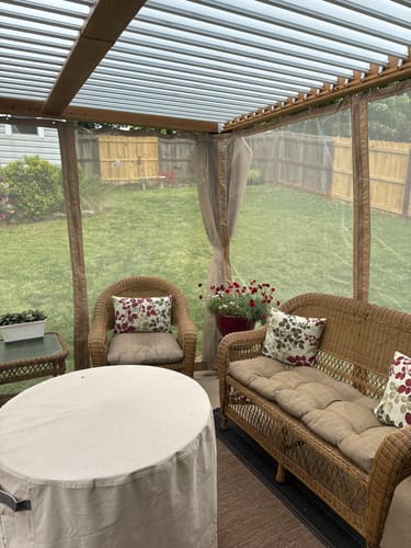 Customer photo review of EROMMY 10x10 Louvered Pergola with Adjustable Rainproof Roof, Wood Grain Outdoor Aluminum Pergola, Curtains and Netting Included