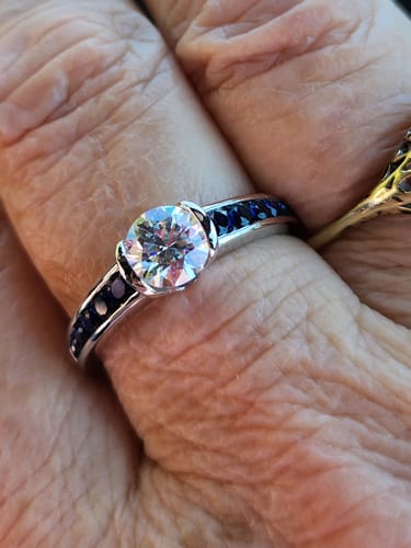 Customer photo review of Half Bezel Moissanite With Sapphire Channel Set Engagement Ring