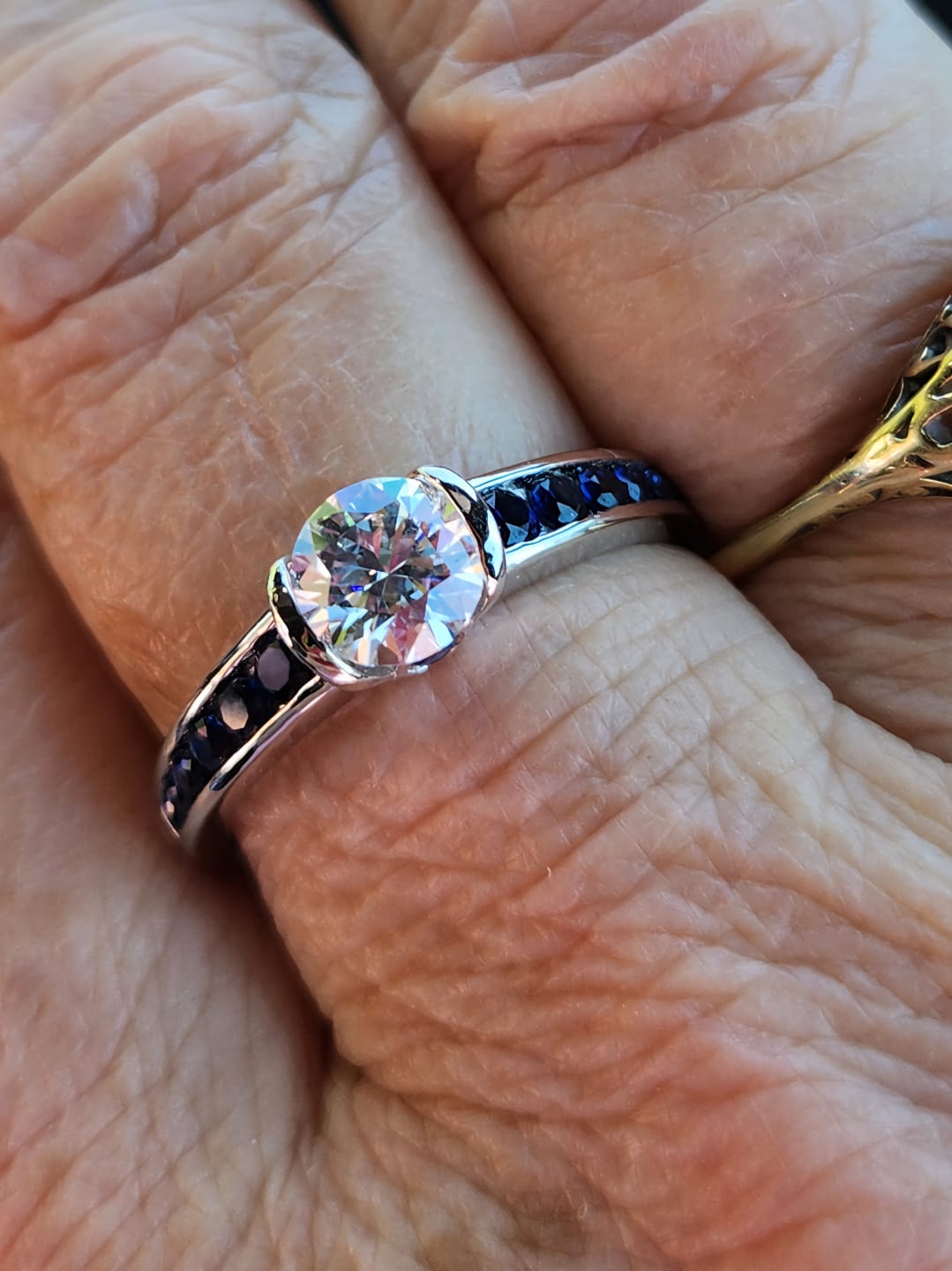 Customer photo review of Half Bezel Moissanite With Sapphire Channel Set Engagement Ring