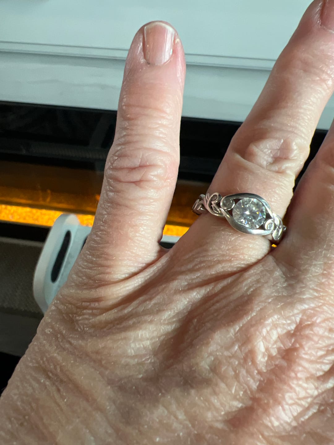 Customer photo review of Bezel Set Round Moissanite Scroll Accents Engagement Ring