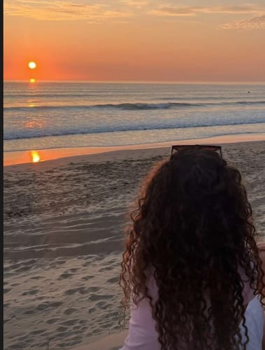 Customer photo review of Light Brown Curly Clip-In Hair Extensions