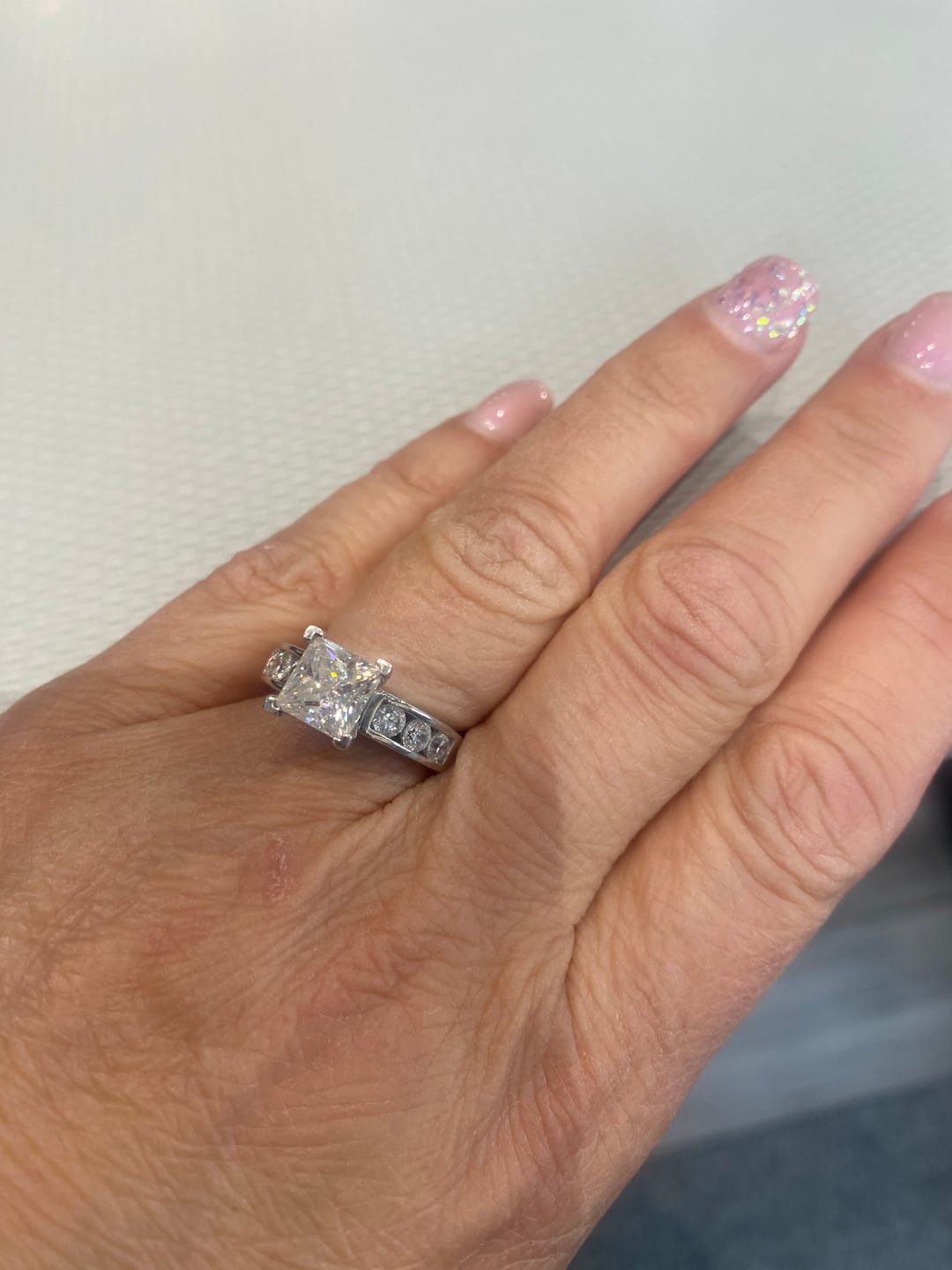 Customer photo review of Princess Cut Moissanite With Round Channel Set Engagement Ring