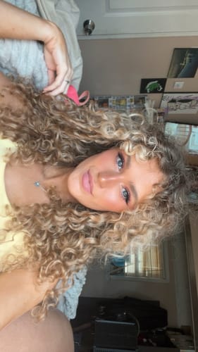 Customer photo review of Ash Blonde Curly Clip-In Hair Extensions