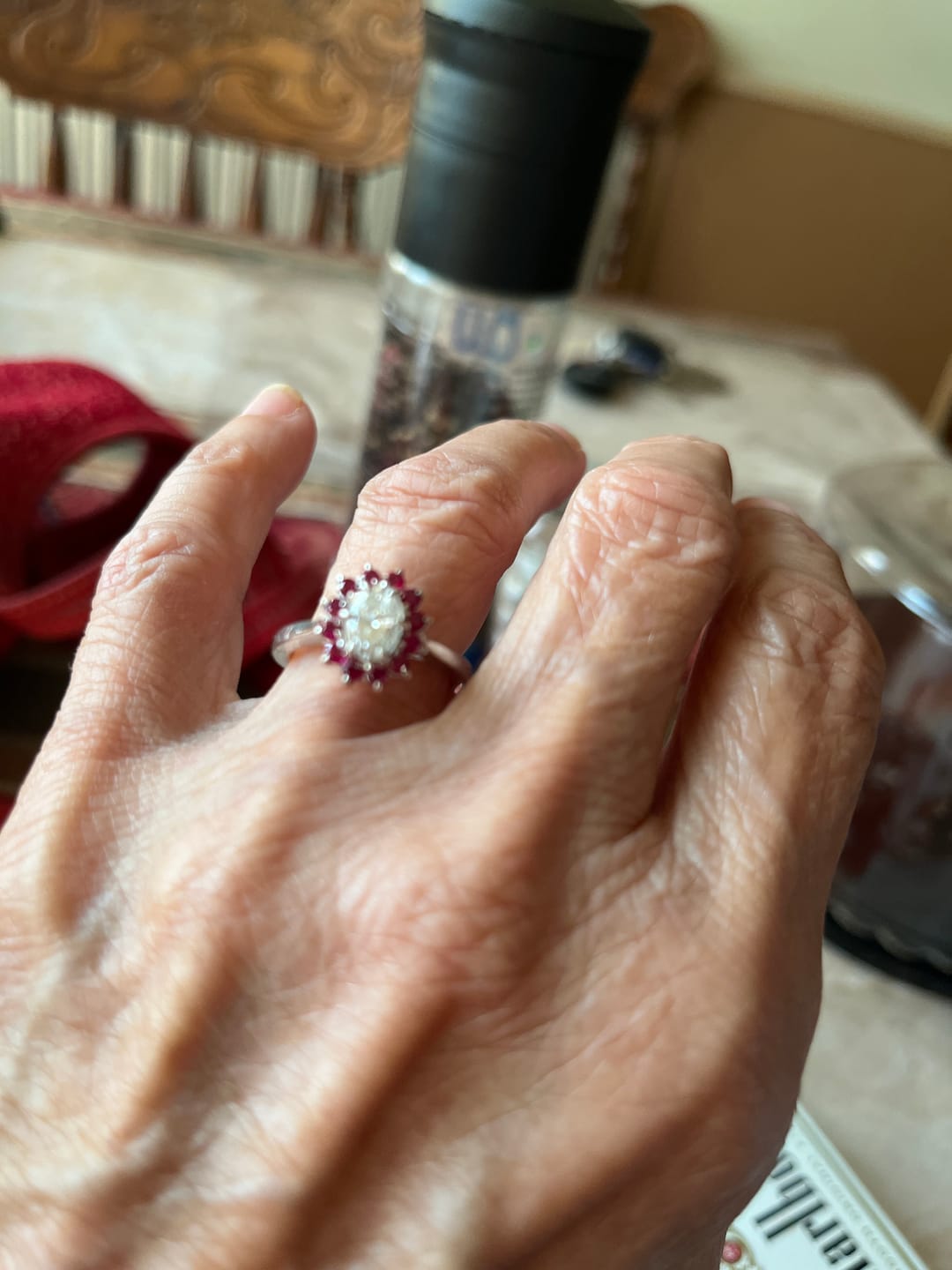 Customer photo review of Oval Moissanite With Floral Ruby Halo Engagement Ring