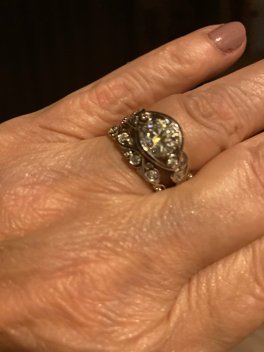 Customer photo review of Bezel Set Round Moissanite Scroll Accents Wedding Band Ring In Sterling Silver