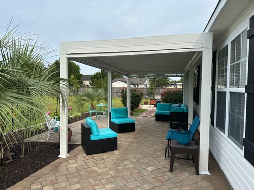 Customer photo review of EROMMY 10×20 FT Aluminum Louvered Pergola with 6-Panel Pull-Down Privacy Screen, Hardtop Rainproof Pergola with Adjustable Roof, White