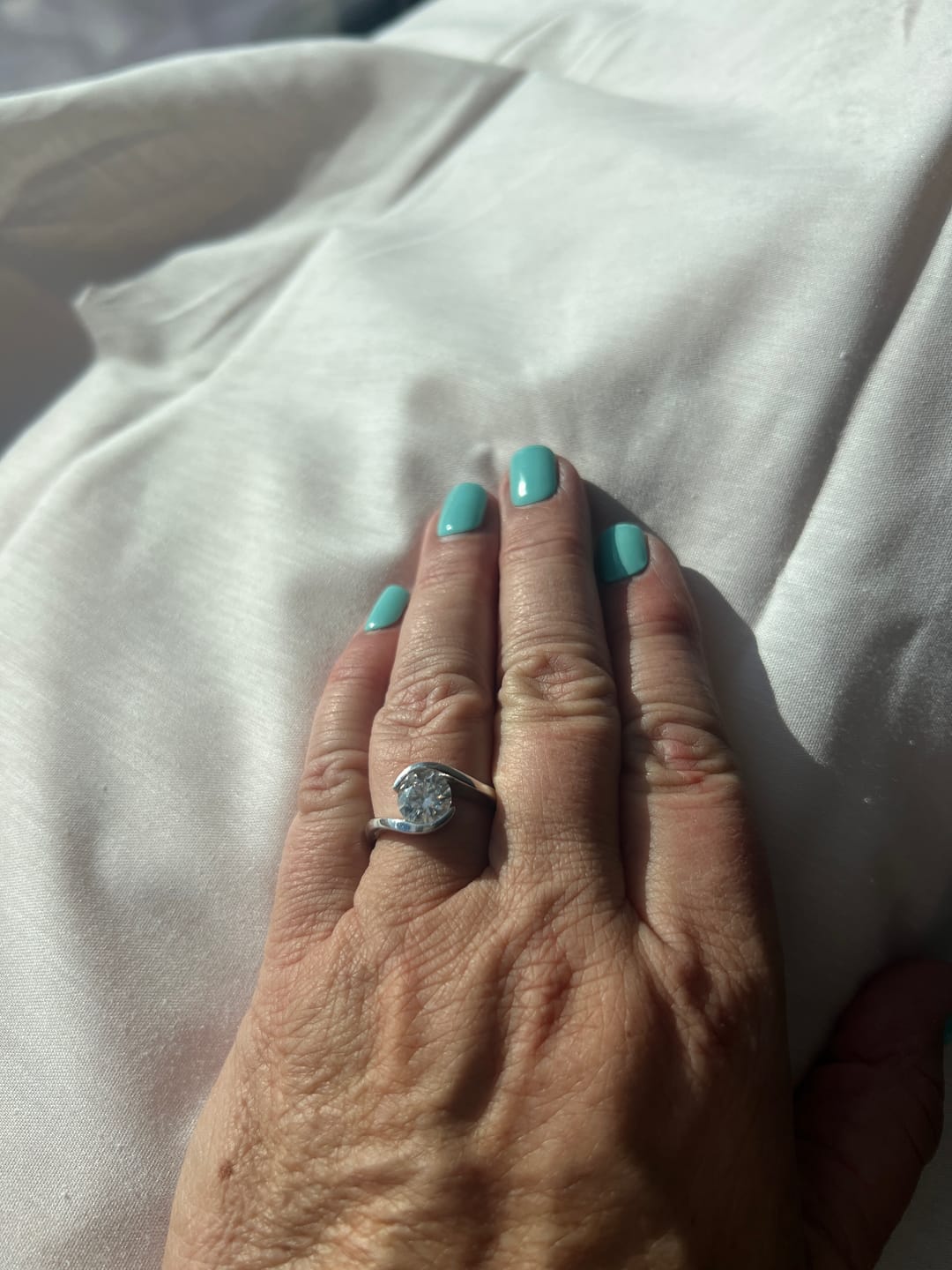 Customer photo review of Solitaire Tension Set Moissanite Bypass Engagement Ring