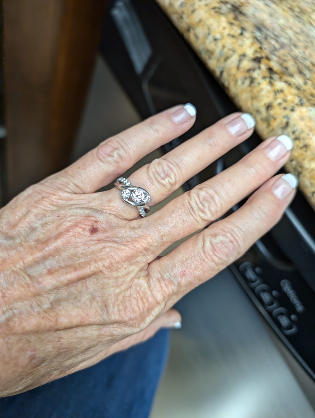 Customer photo review of Swirl Three Stone Moissanite Twisted Pave Engagement Ring