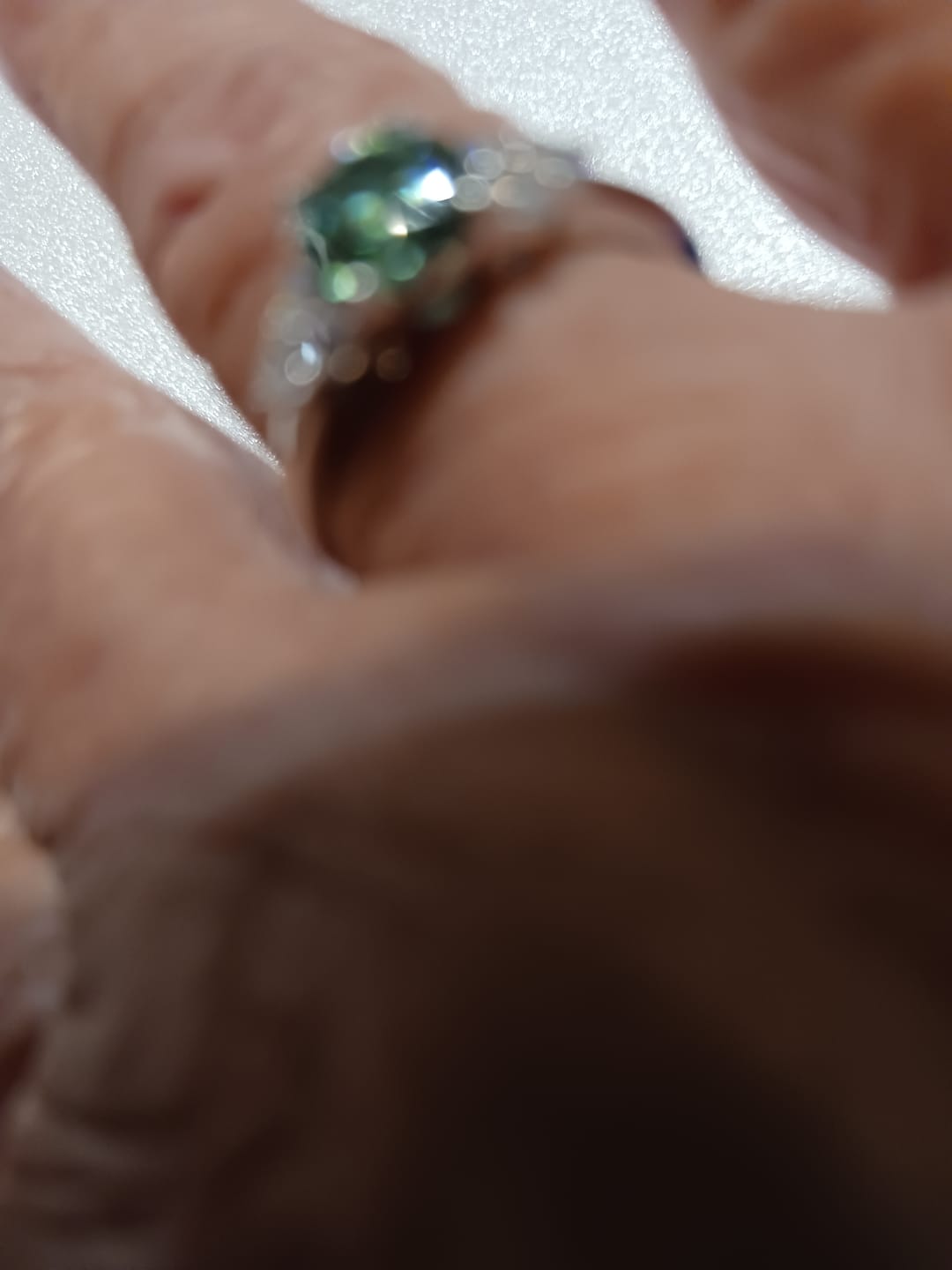 Customer photo review of Green Moissanite Side Stone Engagement Ring