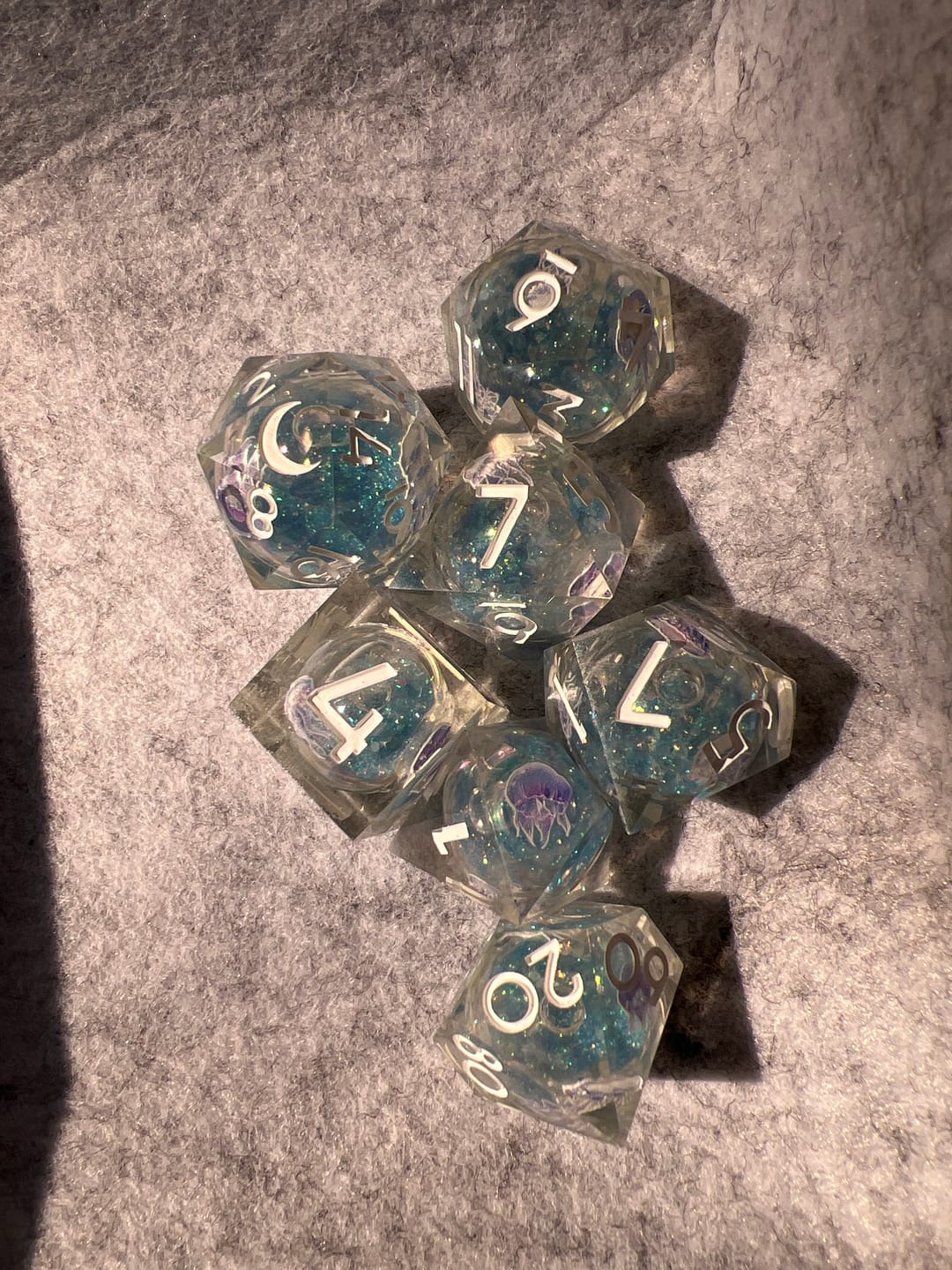 Customer photo review of URWizards D&D Glow in the Dark Liquid Core Resin Engraved Dice Set Jellyfish