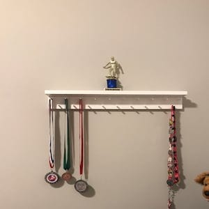 Customer photo review of 2ft Medal Awards Rack Premier Trophy Shelf- Trophy, Plaque and Medal Display