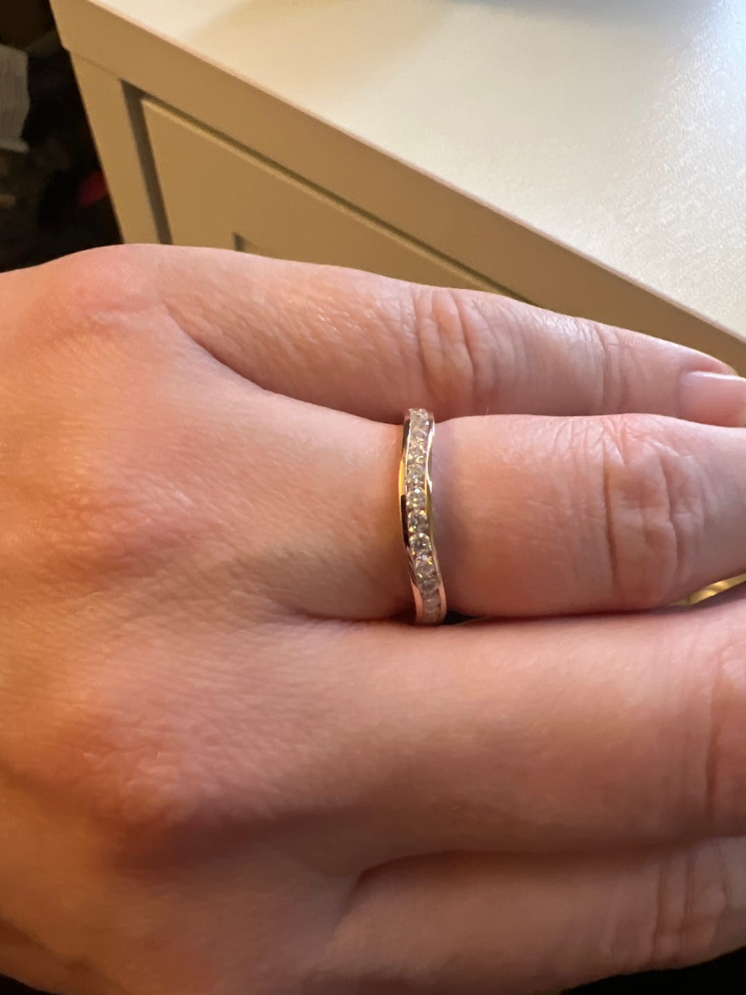 Customer photo review of Doveggs channel set curved moissanite wedding band for women-2.8mm band width