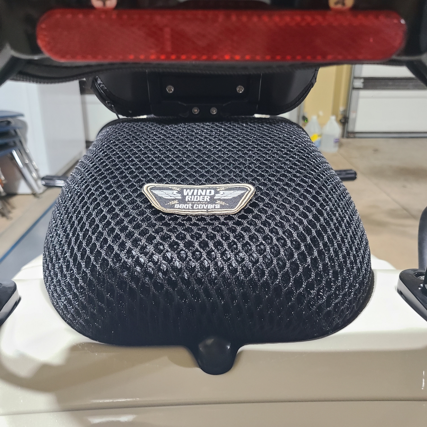 Close-up of the Wind Rider 3D mesh seat cover on a Harley showing the raised airflow weave
